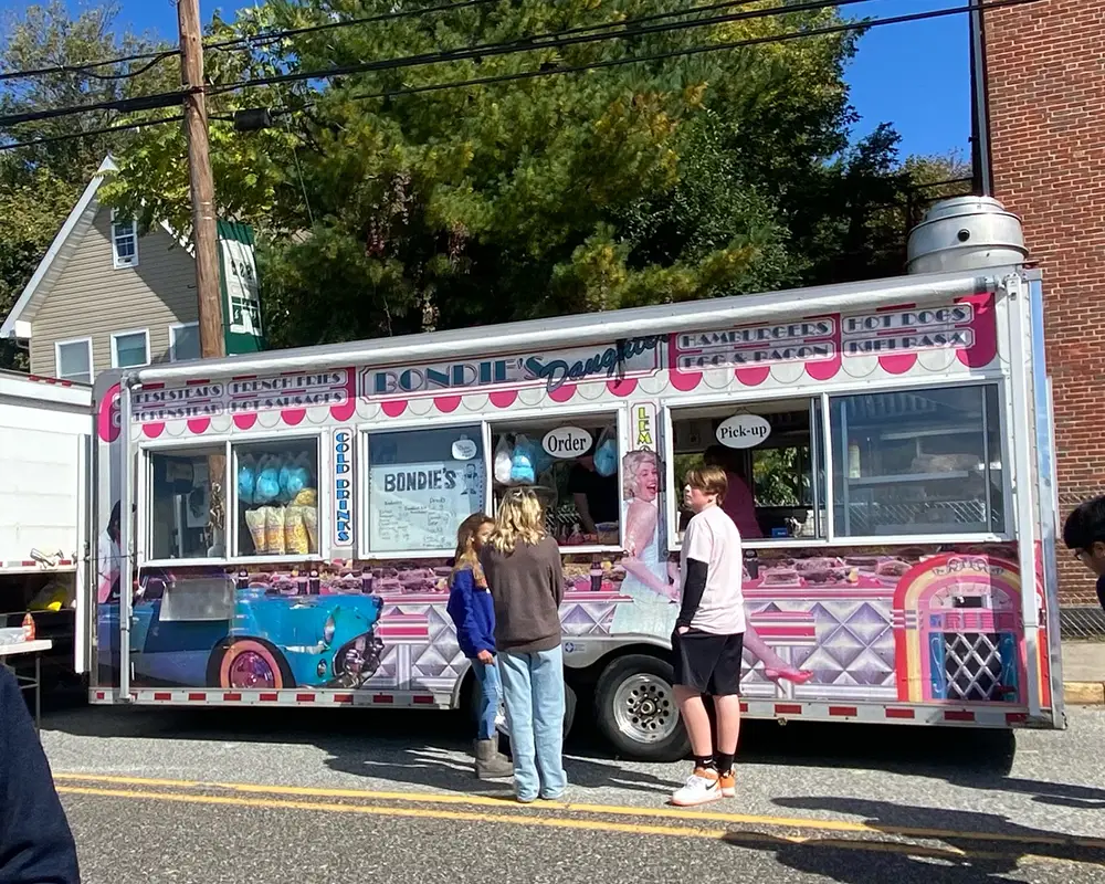Food truck on street with kids ordering food